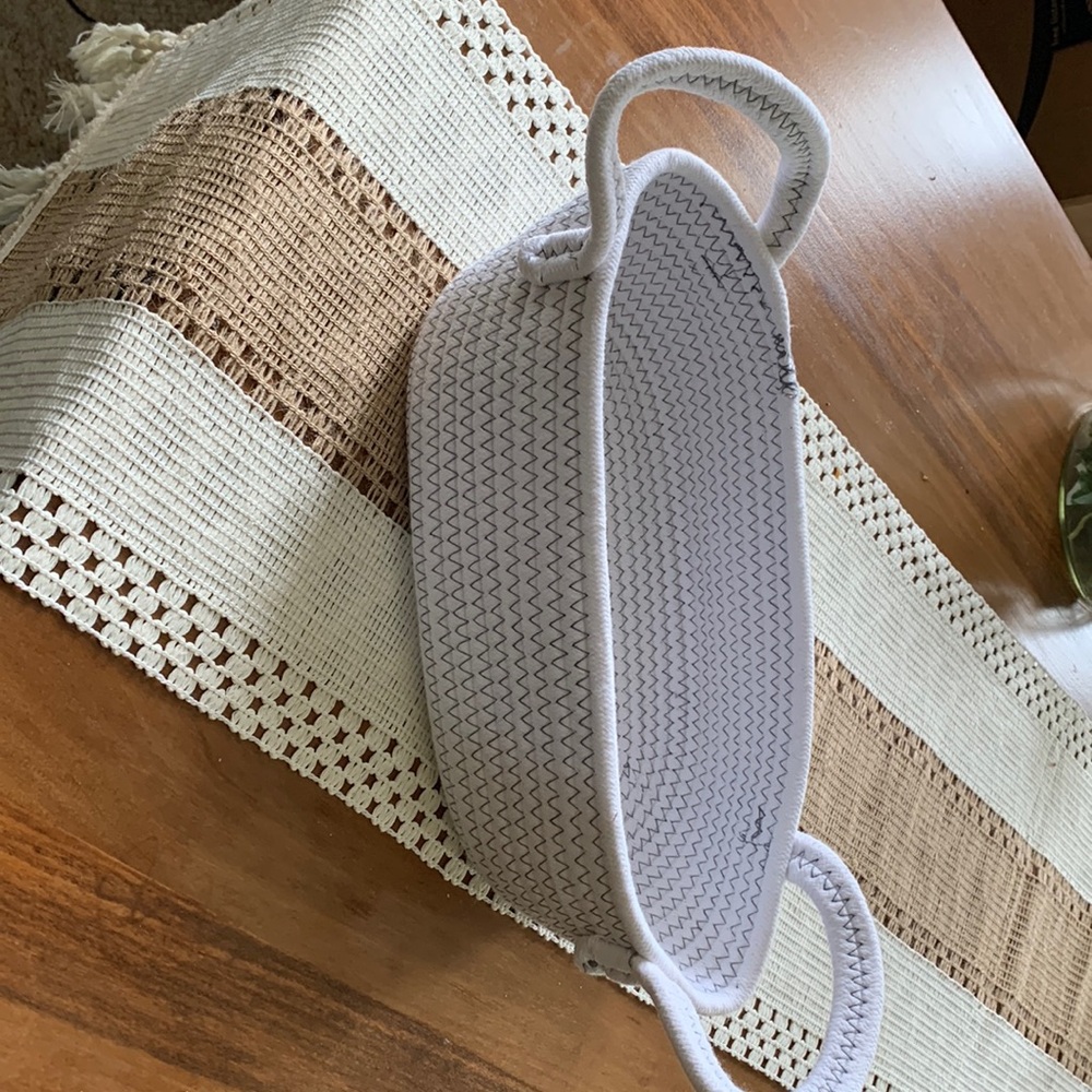 White woven basket with handles.